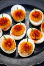 <p>All it takes is a few twists (we're talking a chive stem and a deep orange yolk) to make this traditional recipe festive for Halloween.</p><p><em>Get the recipe at <a href="https://www.delish.com/cooking/recipe-ideas/recipes/a44140/pumpkin-deviled-eggs-recipe/" rel="nofollow noopener" target="_blank" data-ylk="slk:Delish;elm:context_link;itc:0;sec:content-canvas" class="link ">Delish</a>.</em></p>