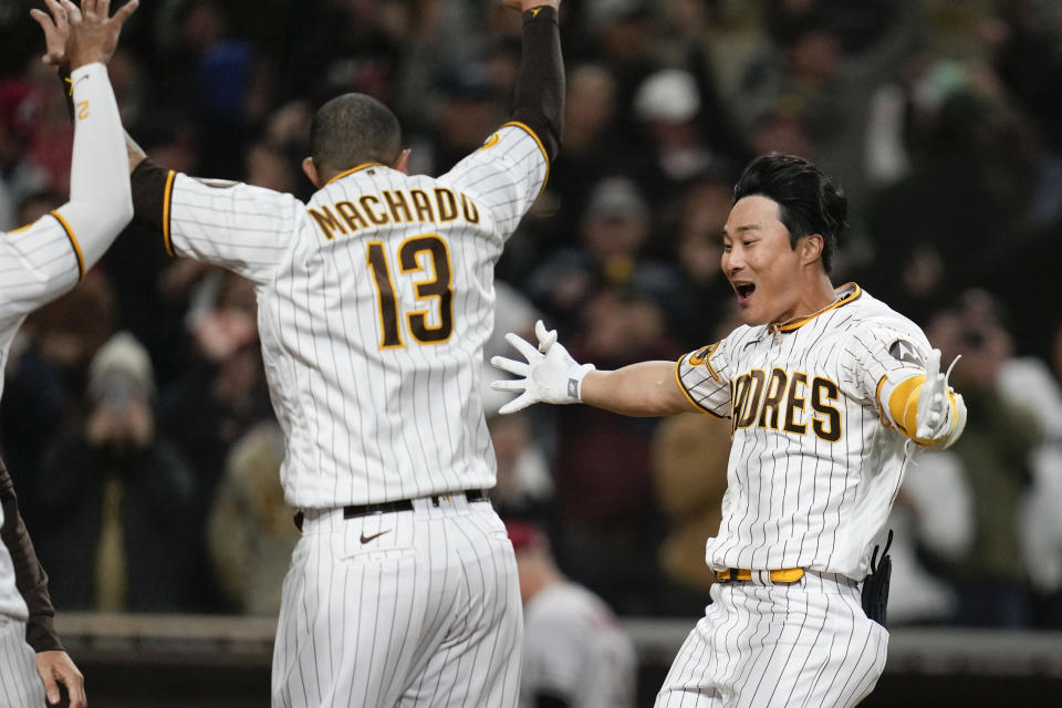 San Diego Padres' Ha-Seong Kim, right, celebrates with teammates after hitting a walk-off home run during the ninth inning of a baseball game against the Arizona Diamondbacks, Monday, April 3, 2023, in San Diego. (AP Photo/Gregory Bull)