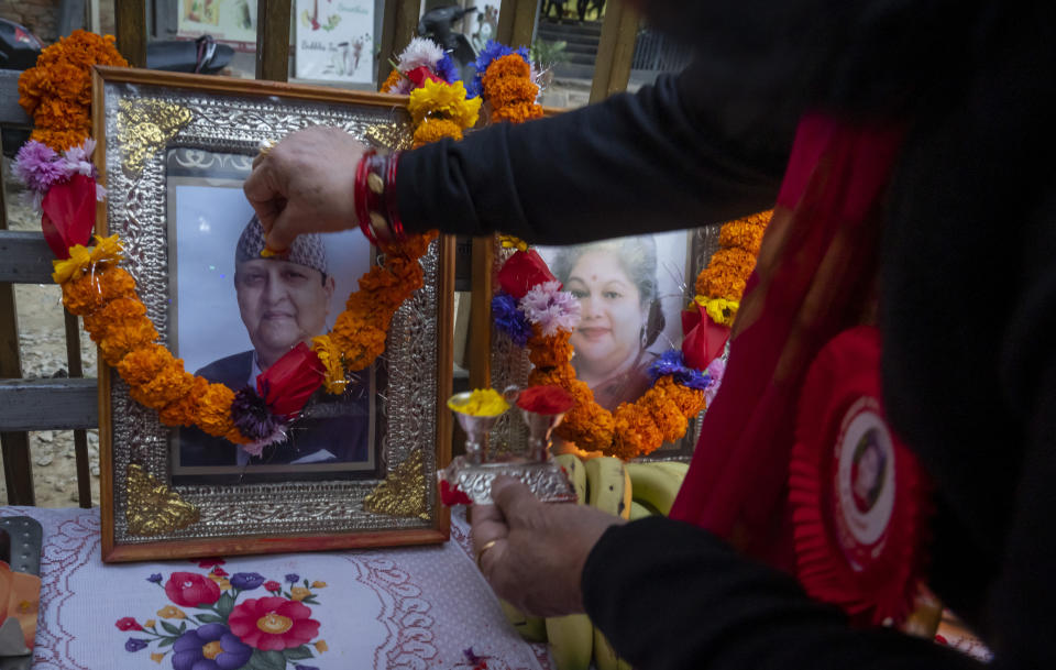 Supporters light candles and worship before photographs former king Gyanendra and former queen Komal Rajya Laxmi Shah as they celebrate the former queen's birthday in Kathmandu, Nepal, Feb. 29, 2024. Nepal’s once unpopular monarchy — abolished after centuries of rule over the Himalayan nation — is hoping to regain some of its lost glory. Royalist groups and supporters of former King Gyanendra have been holding rallies to demand the restoration of the monarchy and the nation’s former status as a Hindu state. (AP Photo/Niranjan Shrestha)