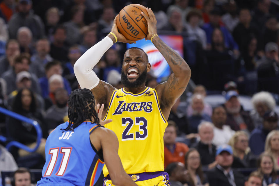 Los Angeles Lakers forward LeBron James (23) looks to pass as Oklahoma City Thunder guard Isaiah Joe (11) defends during the first half of an NBA basketball game, Thursday, Nov. 30, 2023, in Oklahoma City. (AP Photo/Nate Billings)