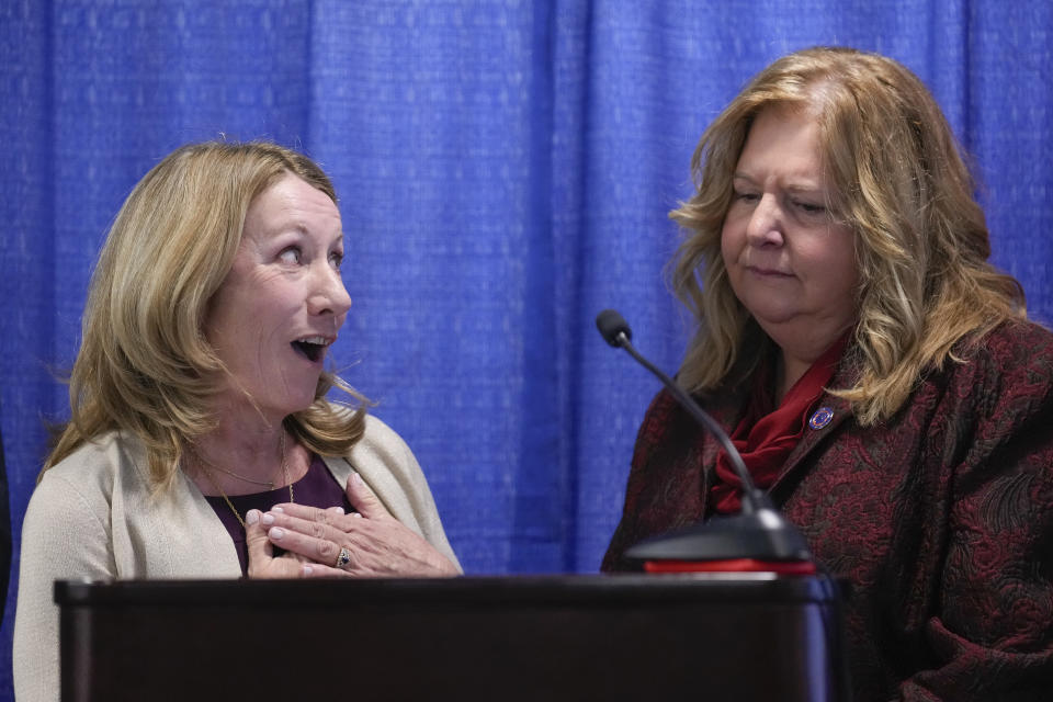 Jeanne Heinz, sister of Mary Beth Heinz, left, thanks law enforcement, including Nassau County District Attorney Anne Donnelly, right, during a news conference after Richard Cottingham appeared remotely in a courtroom in Mineola, N.Y., Monday, Dec. 5, 2022. Cottingham, the serial murderer known as the "Torso Killer", admitted Monday to killing a 23-year-old woman outside a Long Island shopping mall in 1968 and four other women decades ago, including Mary Beth Heinz. (AP Photo/Seth Wenig)