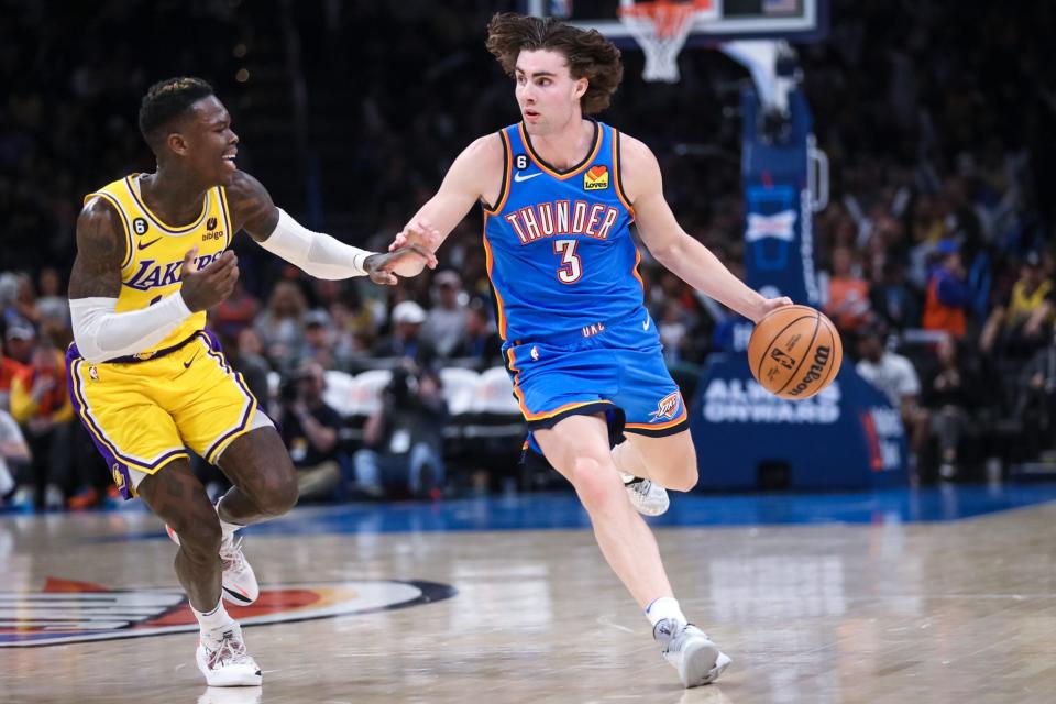 Oklahoma City guard Josh Giddey (3) looks to pass past Los Angeles guard Dennis Schroder (17) in the third quarter of an NBA game between the Oklahoma City Thunder and the Los Angeles Lakers at the Paycom Center in Oklahoma City on Wednesday, March 1, 2023. 