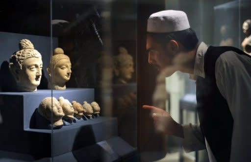 A student looks at Buddha statue heads at the National Museum of Afghanistan in Kabul. Afghanistan, which achieved notoriety for cultural barbarism when Taliban Islamists blew up the ancient Bamiyan Buddhas, this week opened an exhibition highlighting the country's Buddhist heritage