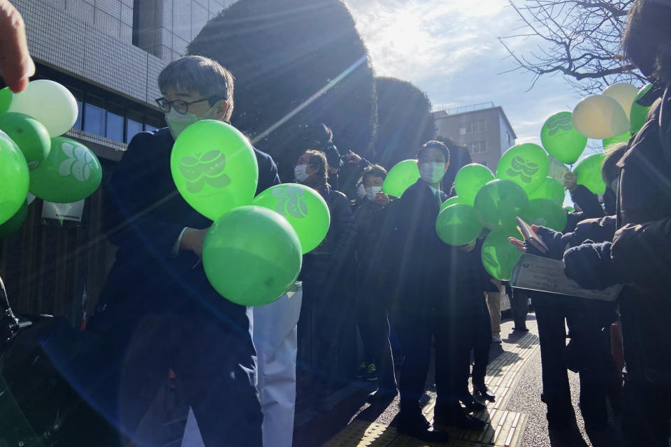 Supporters of six plaintiffs who were children at the time of the 2011 Fukushima nuclear plant disaster and have since developed thyroid cancer stand outside the Tokyo District Court in Tokyo, Thursday, Jan. 27, 2022. Six people who were children living in Fukushima at the time of the 2011 nuclear disaster and have since developed thyroid cancer filed a lawsuit Thursday demanding a utility pay compensation for their illnesses, which they say were triggered by massive radiation spewed from the Fukushima nuclear plant. (AP Photo/Mari Yamaguchi)