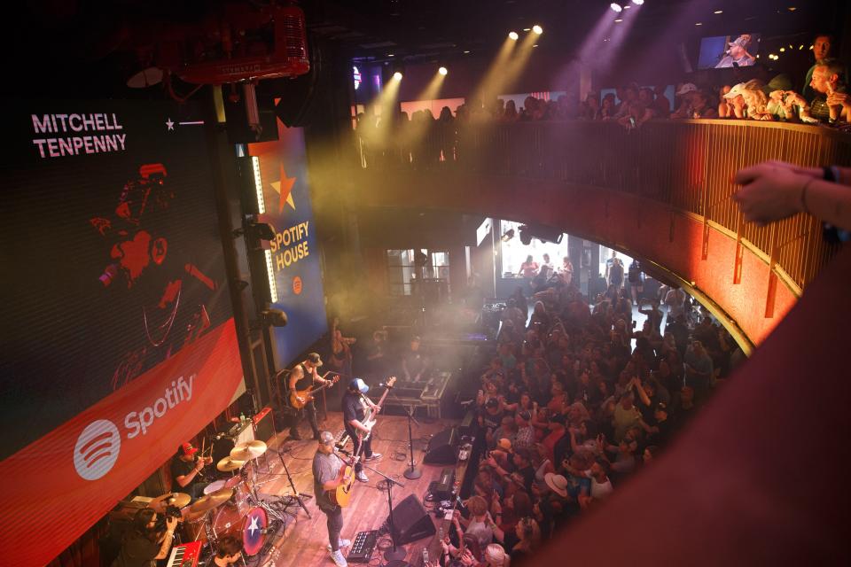 Fans crowd inside Spotify House at Ole Red to watch Mitchell Tenpenny as weather shuts down stages during the 50th annual CMA Fest in Nashville, Tenn. on Sunday, June 11, 2023