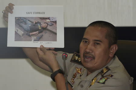 Jakarta Police medical division chief officer Musyafak shows a photo of suspected dead militant identified as Afif, alias Sunakin, at Jakarta police headquarters, Indonesia January 16, 2016 in this photo taken by Antara Foto. REUTERS/Sigid Kurniawan/Antara Foto