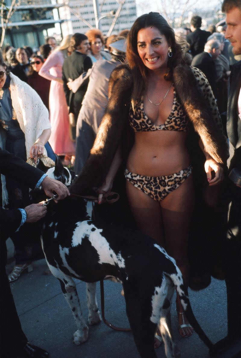 <p> The year is 1974. The outfit is a leopard printed bikini underneath a spotted furry coat. Perhaps she had a backup gown...in the car? </p>