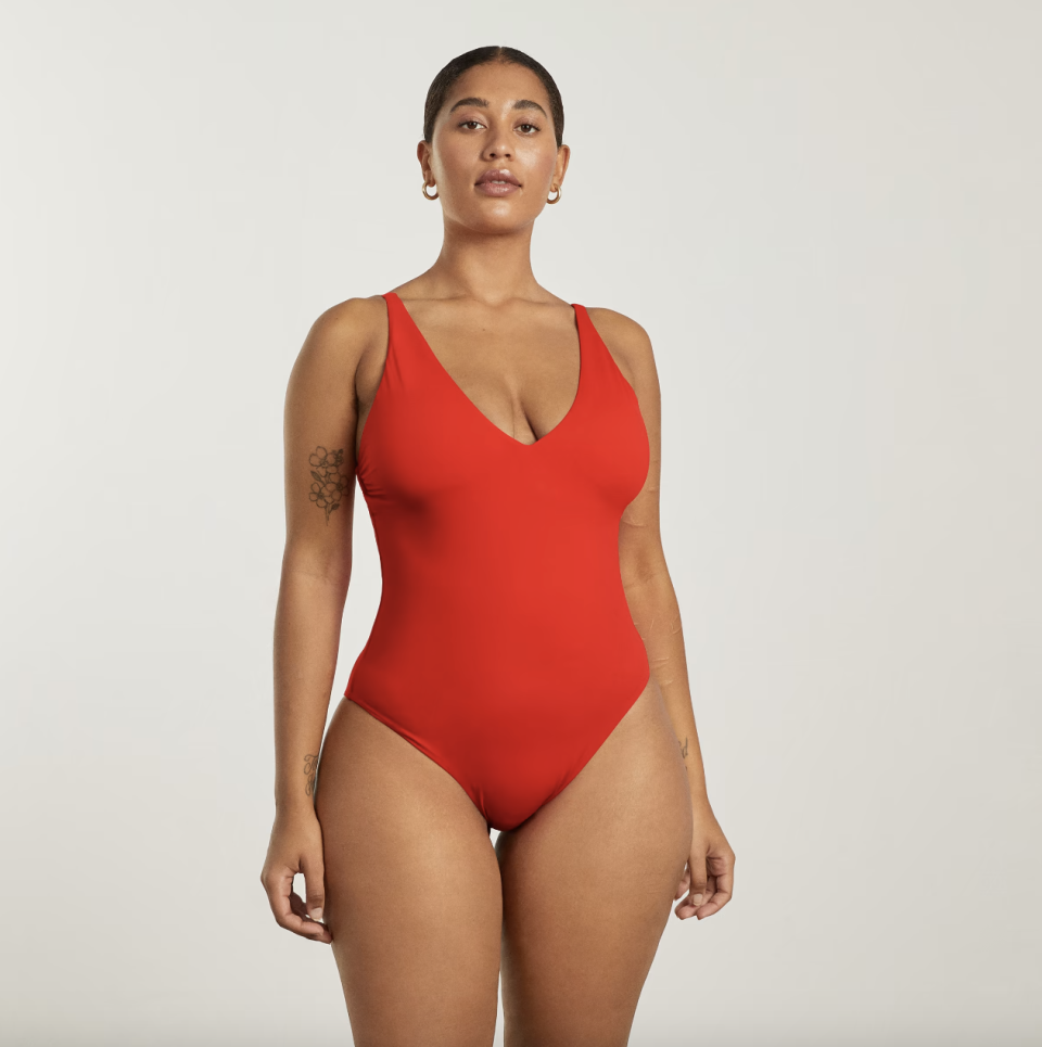 model wearing V-Neck One-Piece bathing suit in bright red 