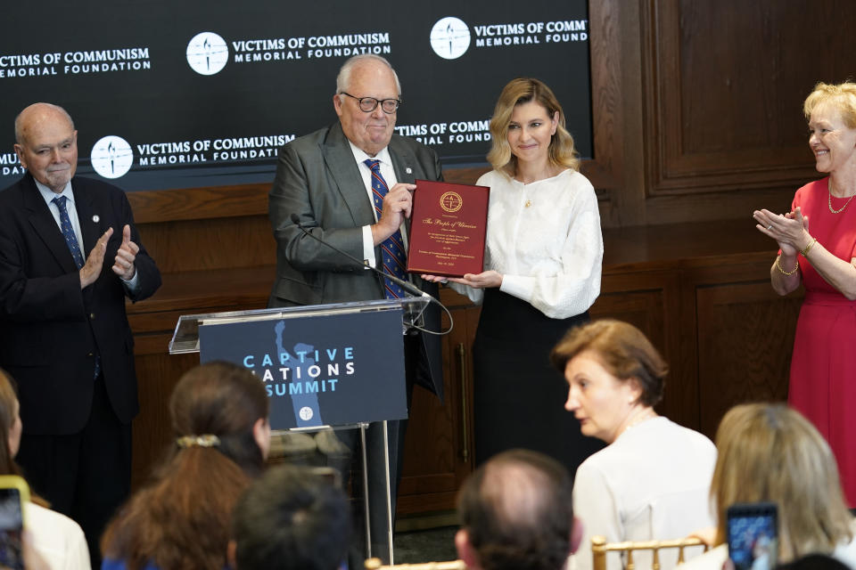 Olena Zelenska, spouse of Ukrainian's President Volodymyr Zelenskyy, accepts the Dissident Human Rights Award on behalf of the people of Ukraine for their brave fight against Russia from Dr. Edwin Feulner chairman of the Victims of Communism Memorial Foundation, at the Victims of Communism Museum in Washington, Tuesday, July 19, 2022. At left is Dr. Lee Edwards, Co-Founder and Chairman Emeritus of the Victims of Communism Memorial Foundation and at right is Amb. Aldona Wos. (AP Photo/Carolyn Kaster)