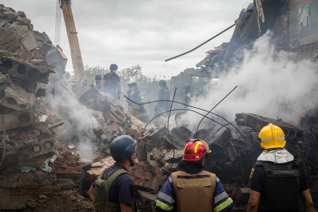 Ukrainian personnel search for survivors in the ruins of the