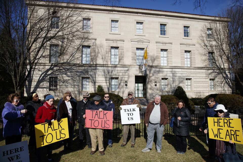 FILE - In this Feb. 16, 2019 file photo, a group with Catholic Laity for Orthodox Bishops and Reform gathers to pray the rosary outside the Apostolic Nunciature of the Holy See in Washington. Pope Francis' high-stakes sex abuse prevention summit is meant to call attention to the crisis as a global problem that requires a global response. After the abuse scandal erupted in Boston in 2002, U.S. bishops adopted the toughest anti-abuse norms in the Catholic Church, a "one strike and you're out" policy that removes any priest from ministry if he commits a single act of abuse that is admitted to or established. (AP Photo/Carolyn Kaste, file)