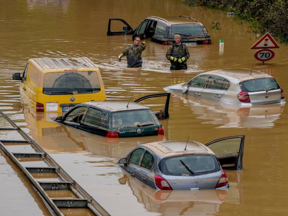 Emergency crews stand in flood water after Germany received heavy rainfall.