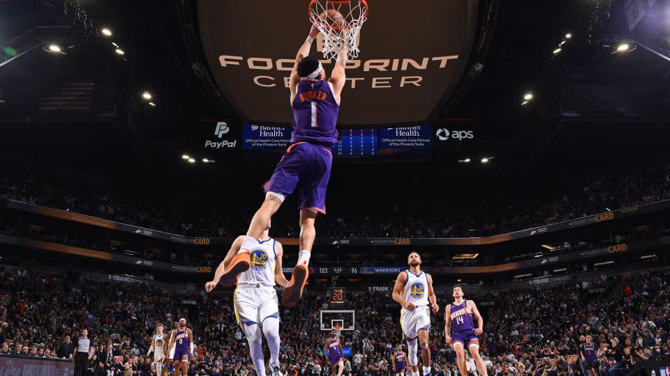 Phoenix's Devin Booker dunks the ball during the game. - Garrett Ellwood/NBAE/Getty Images
