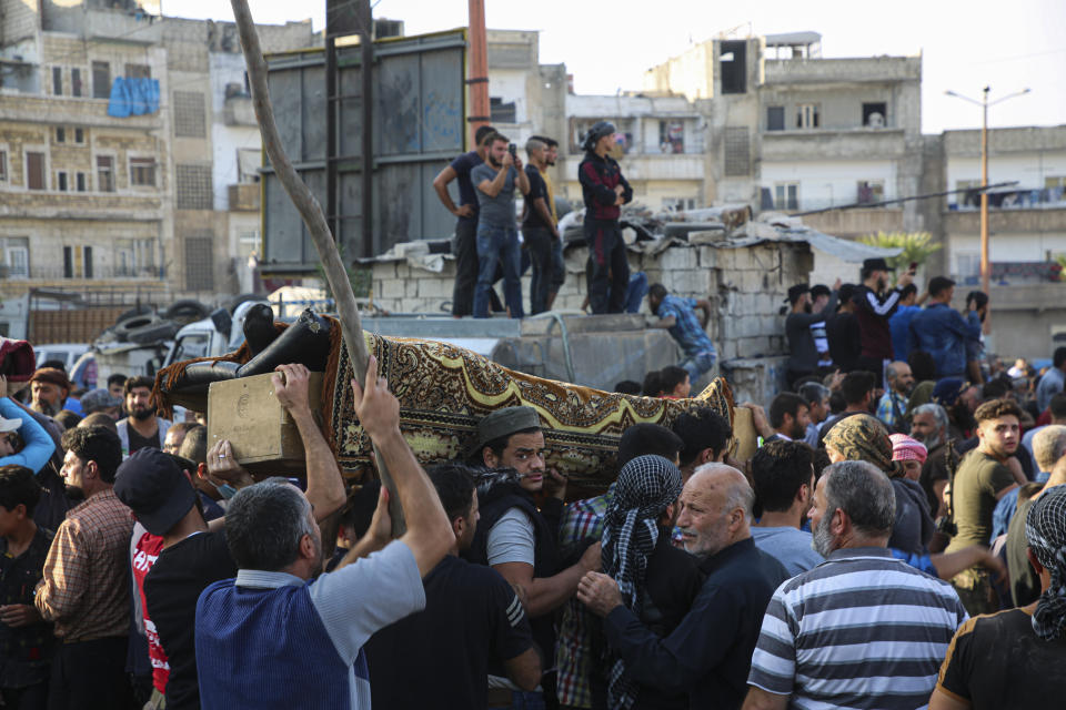 People attend funeral of fighters killed in an airstrike in the town of Idlib, Syria, Monday, Oct. 26, 2020. An airstrike on a rebel training camp in northwestern Syria on Monday killed dozens of Turkish-backed fighters and wounded nearly as many, in one of the heaviest blows to the opposition's strongest groups, a spokesman and a war monitor said. (AP Photo)