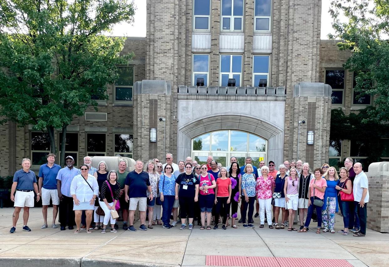 Attendees for the class of 1973 50th reunion gather for a portrait outside Adams High School in South Bend.