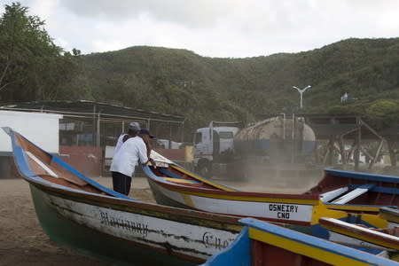 A gasoline tank truck drives past a gas station in the bay of Rio Caribe, a town near caribbean islands, in the eastern state of Sucre, Venezuela October 29, 2015. REUTERS/Carlos Garcia Rawlins