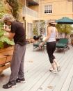 <p>Is that ... is that Harry Hamlin?! The star's husband of more than two decades was hilariously unimpressed with her moves, ignoring her dance break in favor of his gardening in this playful clip. </p>