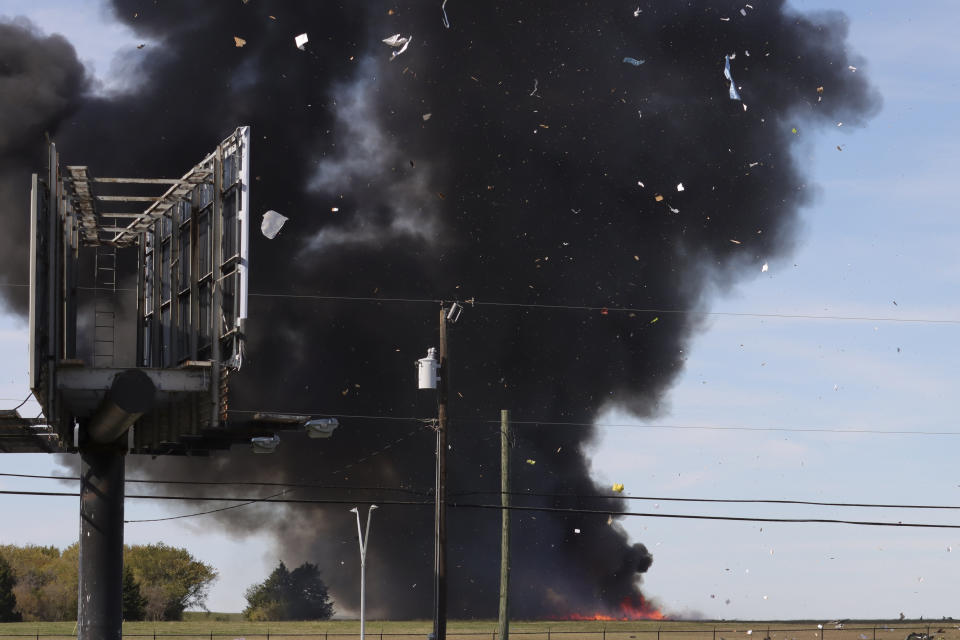 In this photo provided by Nathaniel Ross Photography, a historic military plane crashes after colliding with another plane during an airshow at Dallas Executive Airport in Dallas on Saturday, Nov. 12, 2022. (Nathaniel Ross Photography via AP)