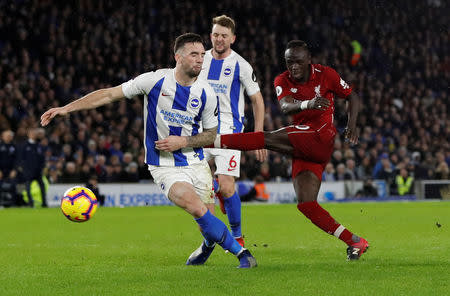 Soccer Football - Premier League - Brighton & Hove Albion v Liverpool - The American Express Community Stadium, Brighton, Britain - January 12, 2019 Liverpool's Sadio Mane shoots at goal as Brighton's Shane Duffy attempts to block Action Images via Reuters/Paul Childs