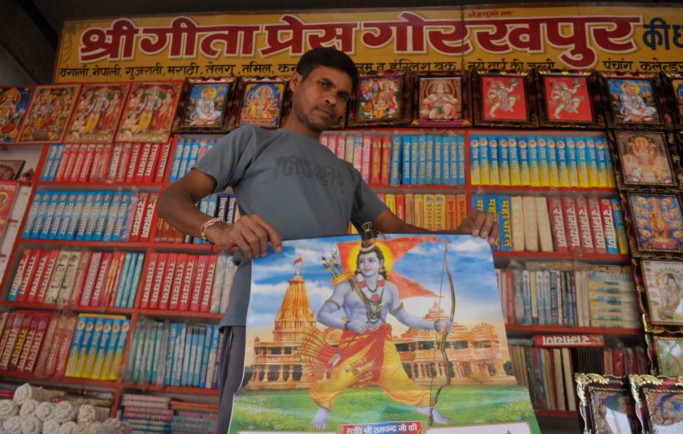 AYODHYA, INDIA - AUGUST 4: A vendor holds up a poster featuring the Hindu god Ram, on the eve of the foundation stone laying ceremony of the Ram Janmabhumi temple on August 4, 2020 in Ayodhya, India. Prime Minister Narendra Modi will on Wednesday attend a public function on laying of the foundation stone of 'Shree Ram Janmabhoomi Mandir' at Ayodhya. Ram Janmabhoomi Teerth Kshetra, the trust set up for the construction and management of Ram temple, has invited 175 eminent guests for the foundation stone-laying ceremony after personally discussing with BJP veterans L K Advani and Murli Manohar Joshi, lawyer K Parasaran and other dignitaries. (Photo by Deepak Gupta/Hindustan Times via Getty Images)