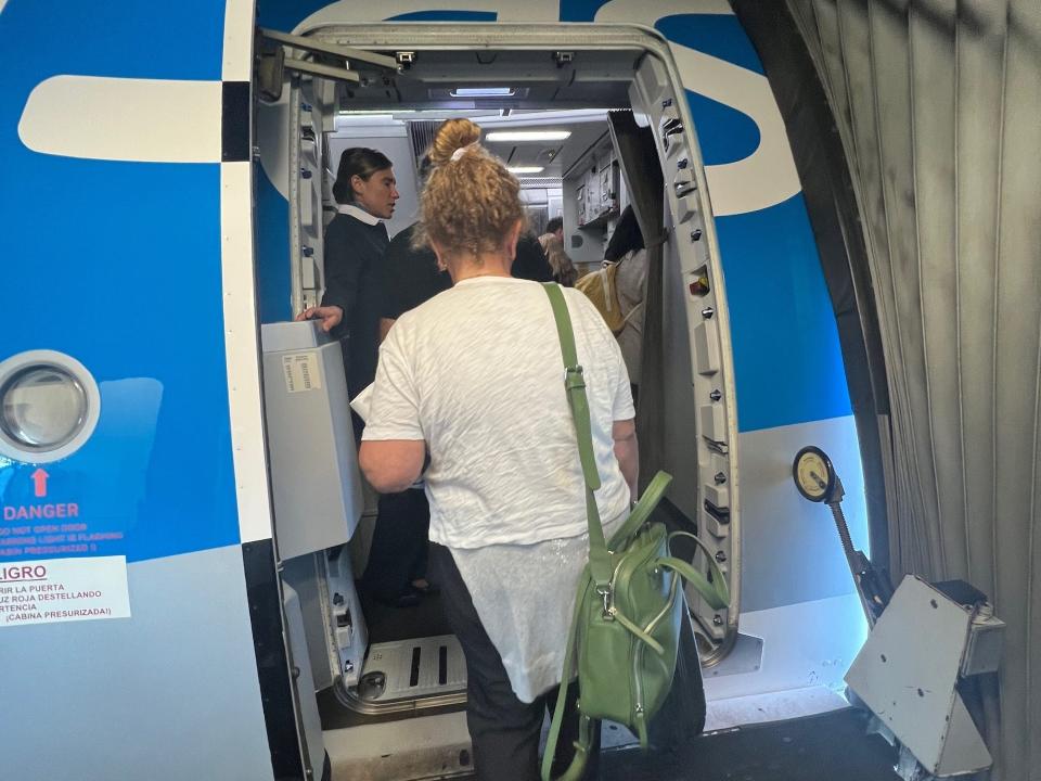 Boarding Aerolineas' blue A330 aircraft.