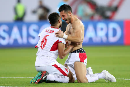 Soccer Football - AFC Asian Cup - Jordan v Syria - Group B - Sheikh Khalifa International Stadium, Al Ain, United Arab Emirates - January 10, 2019 Jordan's Saeed Al-Murjan celebrates with Anas Bani Yassen after the match REUTERS/Suhaib Salem