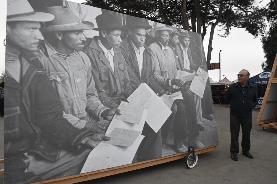 A visitor observes a Bracero photo display at the Salinas Sports Complex in Salinas.