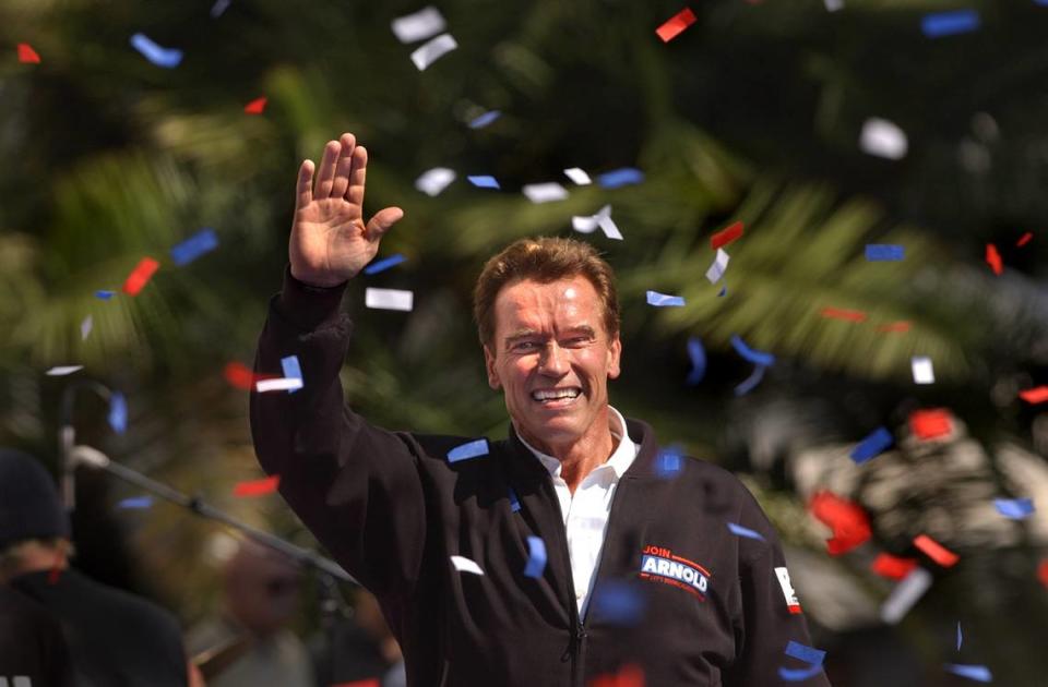Republican gubernatorial candidate Arnold Schwarzenegger waves to cheering supporters after a speaking at a rally at the Capitol on Oct. 5, 2003.