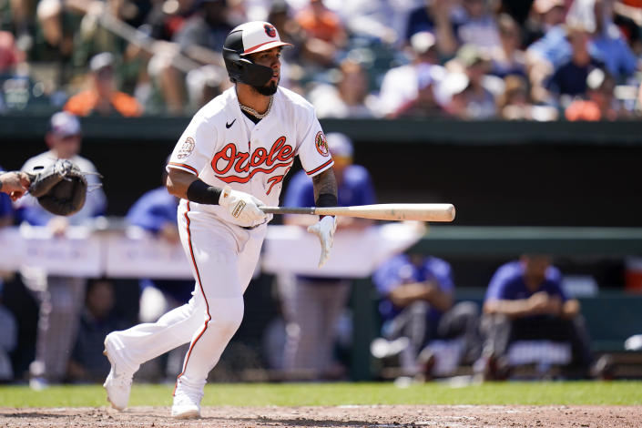 Baltimore Orioles' Jonathan Arauz watches his ball as Texas Rangers first baseman Nathaniel Lowe commits an error on it allowing the Orioles to score two runs during the sixth inning of a baseball game, Monday, July 4, 2022, in Baltimore. The Orioles won 7-6 in ten innings. (AP Photo/Julio Cortez)