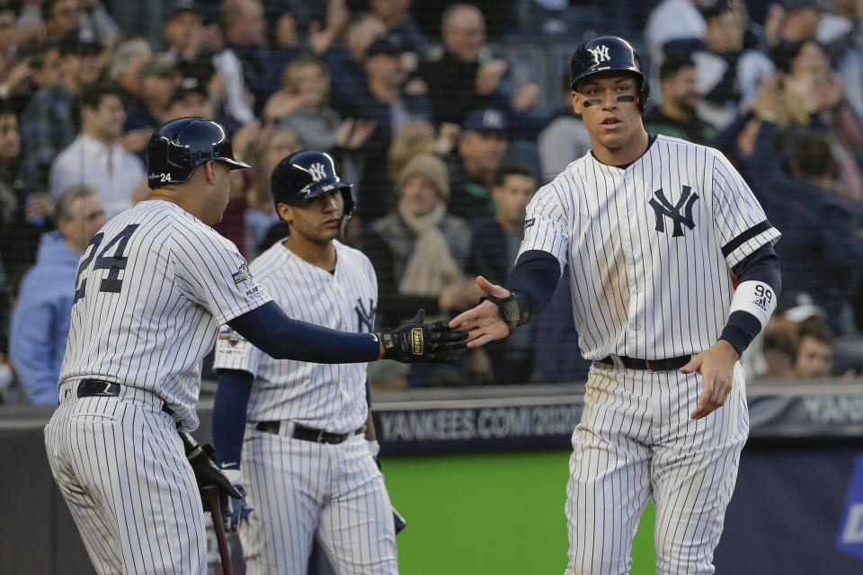 New York Yankees' Aaron Judge, right, celebrates with teammates after scoring against the Minnesota Twins during the third inning of Game 2 of an American League Division Series baseball game, Saturday, Oct. 5, 2019, in New York. (AP Photo/Seth Wenig)