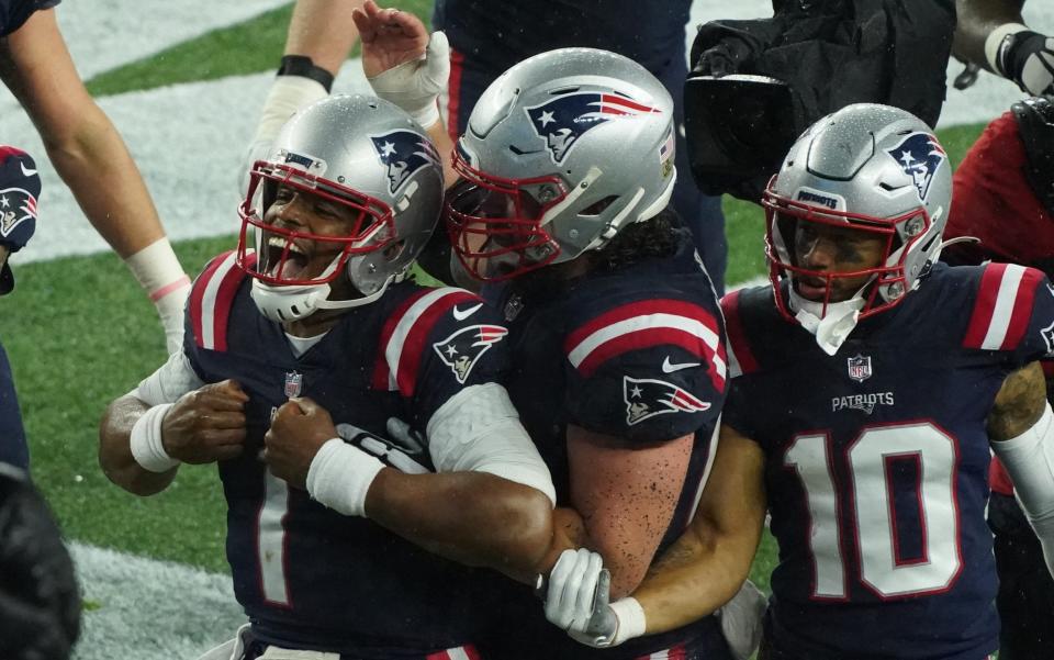 New England Patriots quarterback Cam Newton (1) and his teammates react to the on field TV monitor after scoring against the Baltimore Ravens during the second half at Gillette Stadium. - David Butler II-USA TODAY Sports