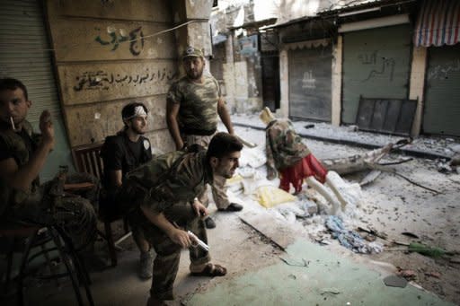 Free Syrian Army fighters man a position in the Old City of Aleppo. Fighting raged in Syria's two biggest cities on Sunday as UN-Arab League envoy Lakhdar Brahimi ended his first visit to the country on a peace mission a rebel commander said was doomed to fail