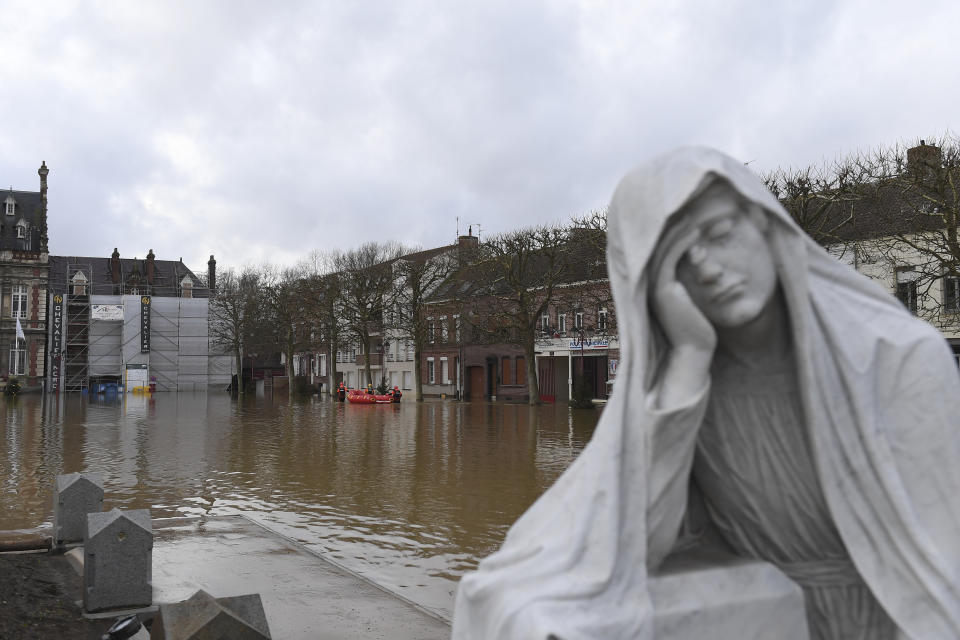 Rescue workers evacuate a person as the Aa river floods Arques, northern France, Thursday, Jan.4, 2024. Heavy rains have pummeled the northern Pas-de-Calais and Nord regions since Sunday, forcing the evacuation of about 200 people and knocking out power to 10,000 households, according to local authorities. (AP Photo/Matthieu Mirville)