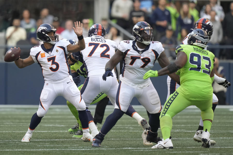 Denver Broncos quarterback Russell Wilson (3) passes for a touchdown against the Seattle Seahawks during the first half of an NFL football game, Monday, Sept. 12, 2022, in Seattle. (AP Photo/Stephen Brashear)