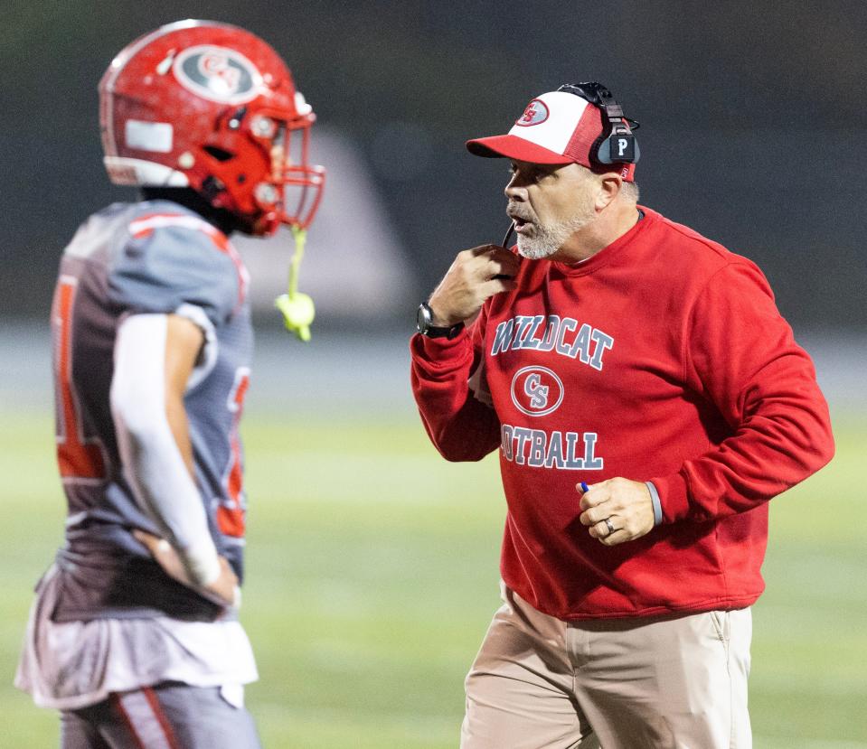 Canton South head coach Matt Dennison talks to Zanden Lewis during a first-round playoff game at home vs. Northwest, Friday, Oct. 27, 2023.