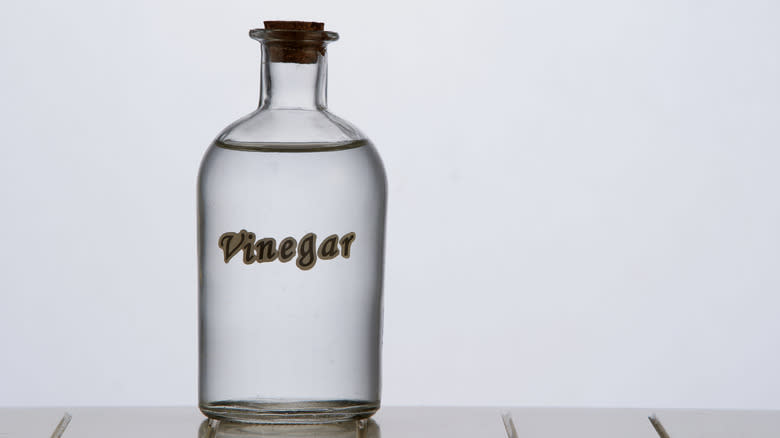 A glass labelled bottle of vinegar