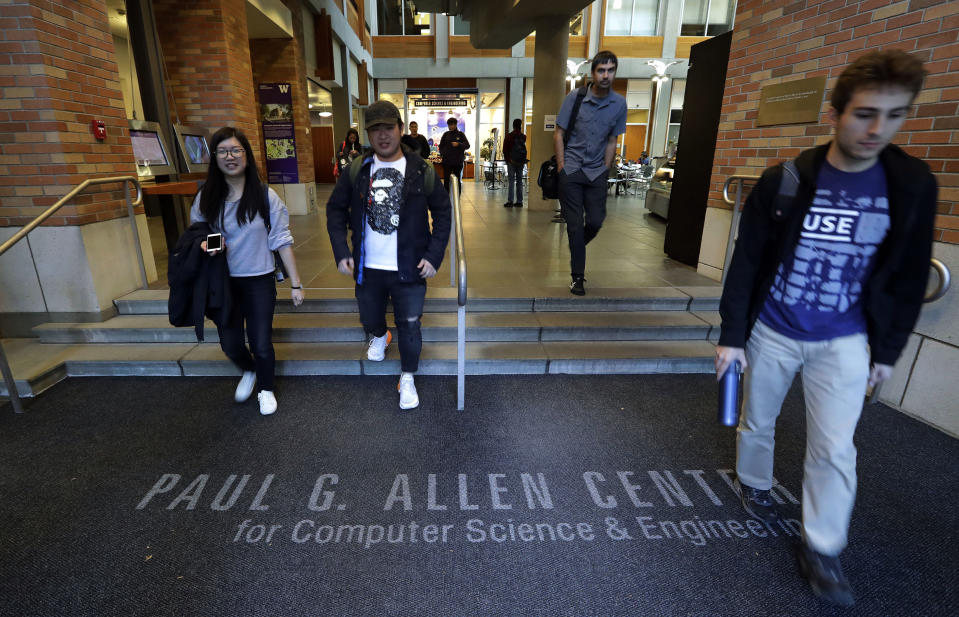 FILE- In this Oct. 15, 2018, file photo students walk out of the Paul G. Allen School of Computer Science & Engineering at the University of Washington in Seattle. Prior to his death on Monday, Allen invested large sums in technology ventures, research projects and philanthropies, some of them eclectic and highly speculative. Outside of bland assurances from his investment company, no one seems quite sure what happens now. (AP Photo/Elaine Thompson, File)