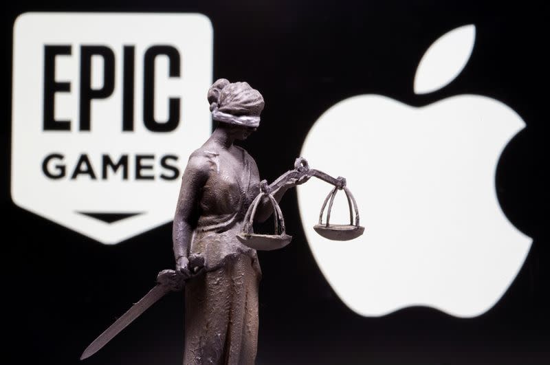 FILE PHOTO: 3D printed Lady Justice figure is seen in front of displayed Apple and Epic Games logos in this illustration photo