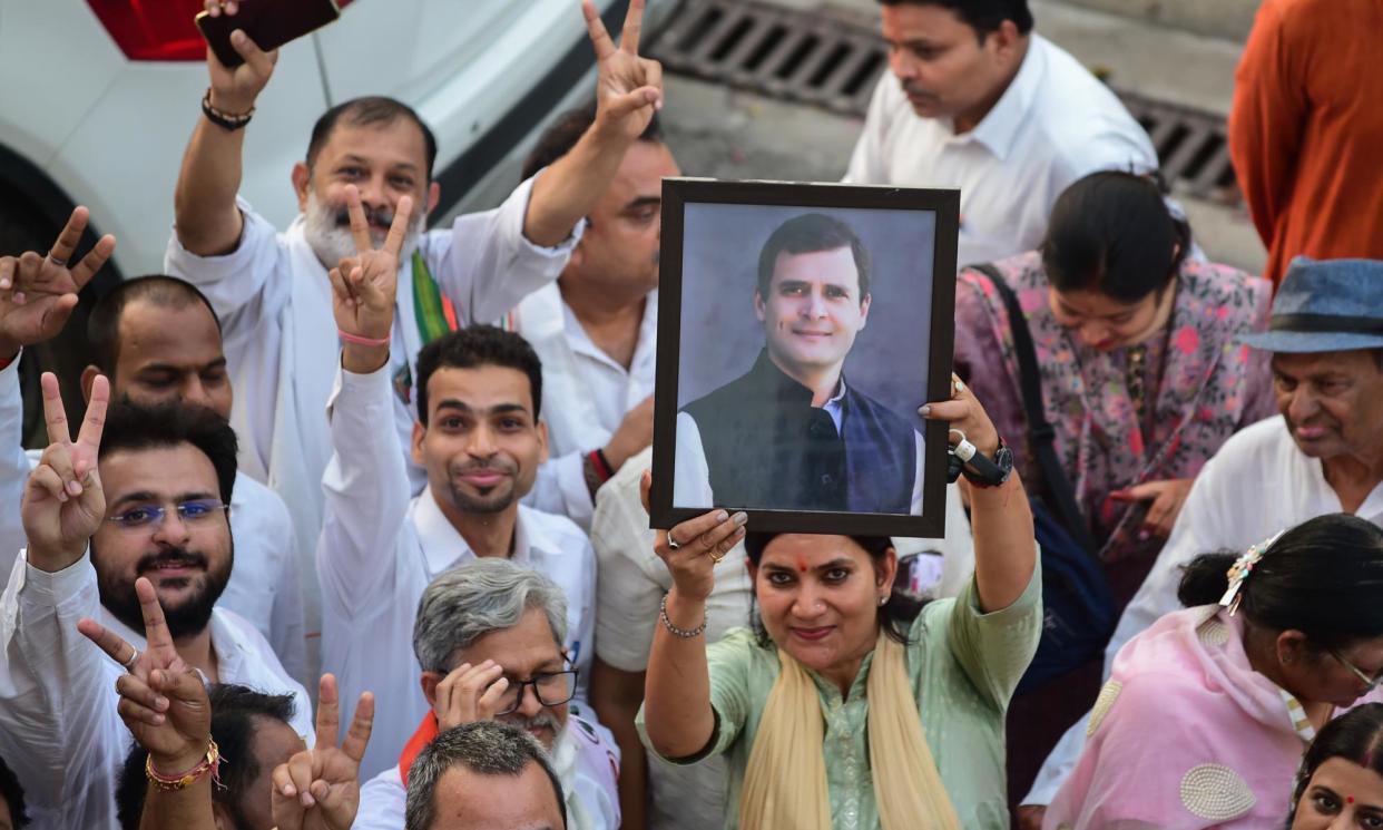 <span>Congress supporters hold up a photograph of Rahul Gandhi. The party has almost doubled its number of parliamentary seats.</span><span>Photograph: Ritesh Shukla/Getty Images</span>