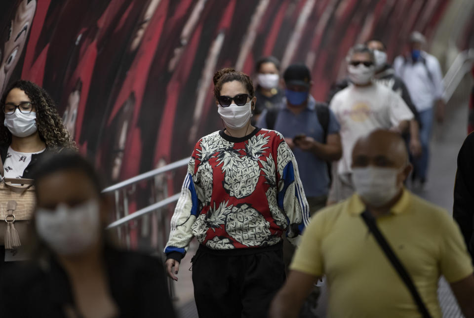 Commuters wear face masks inside the subway system amid the spread of the new coronavirus in Sao Paulo, Brazil, Monday, May 4, 2020. The state government mandated that commuters using public transportation must wear face masks starting Monday. (AP Photo/Andre Penner)