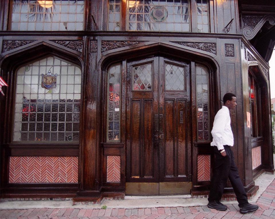An employee stands outside the Blue Anchor Pub in Delray Beach. The entire exterior of the pub was built in 1865 and shipped from England. The original Blue Anchor Pub served a young Winston Churchill and two of Jack the Ripper's victims. Staff photo by Taylor Jones