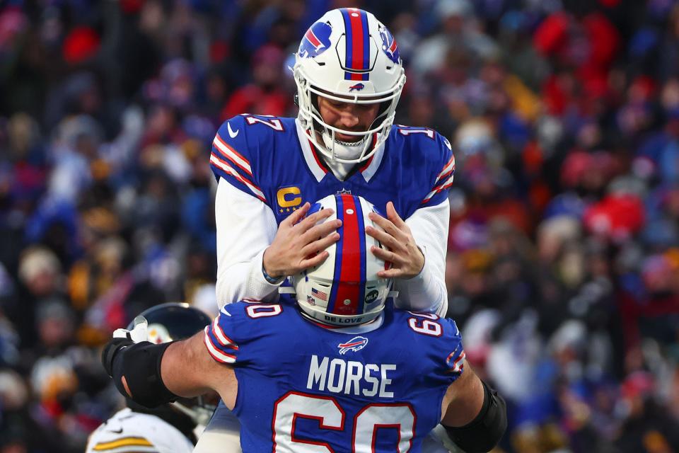 Buffalo Bills quarterback Josh Allen (17) celebrates with center Mitch Morse (60) after throwing a touchdown pass against the Pittsburgh Steelers during the first quarter of an NFL wild-card playoff football game, Monday, Jan. 15, 2024, in Buffalo, N.Y. (AP Photo/Jeffrey T. Barnes)