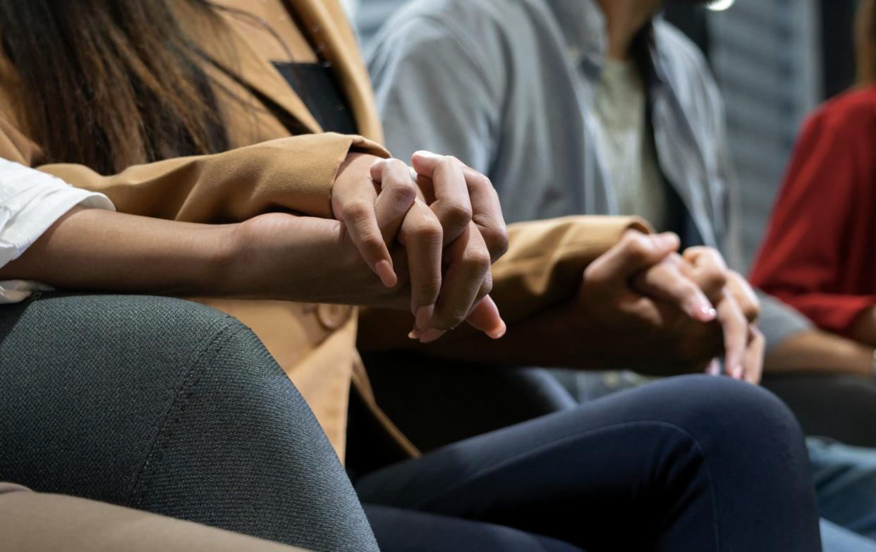 People holding hands during a group therapy session - Moment RF