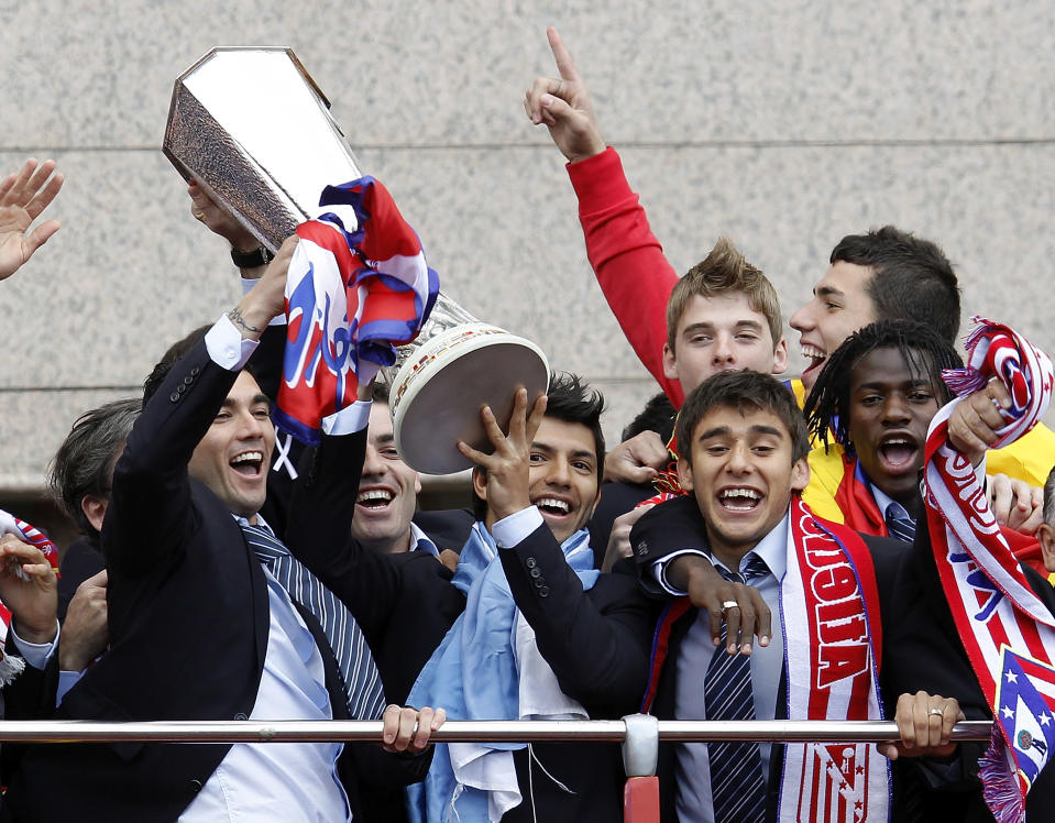 Reyes, Sergio Aguero, Salvio and Ibrahima celebrate with the Europa League trophy on the top of an open bus after beating Fulham 2-1 in Hamburg after extra time. (Photo by Angel Martinez/Getty Images)