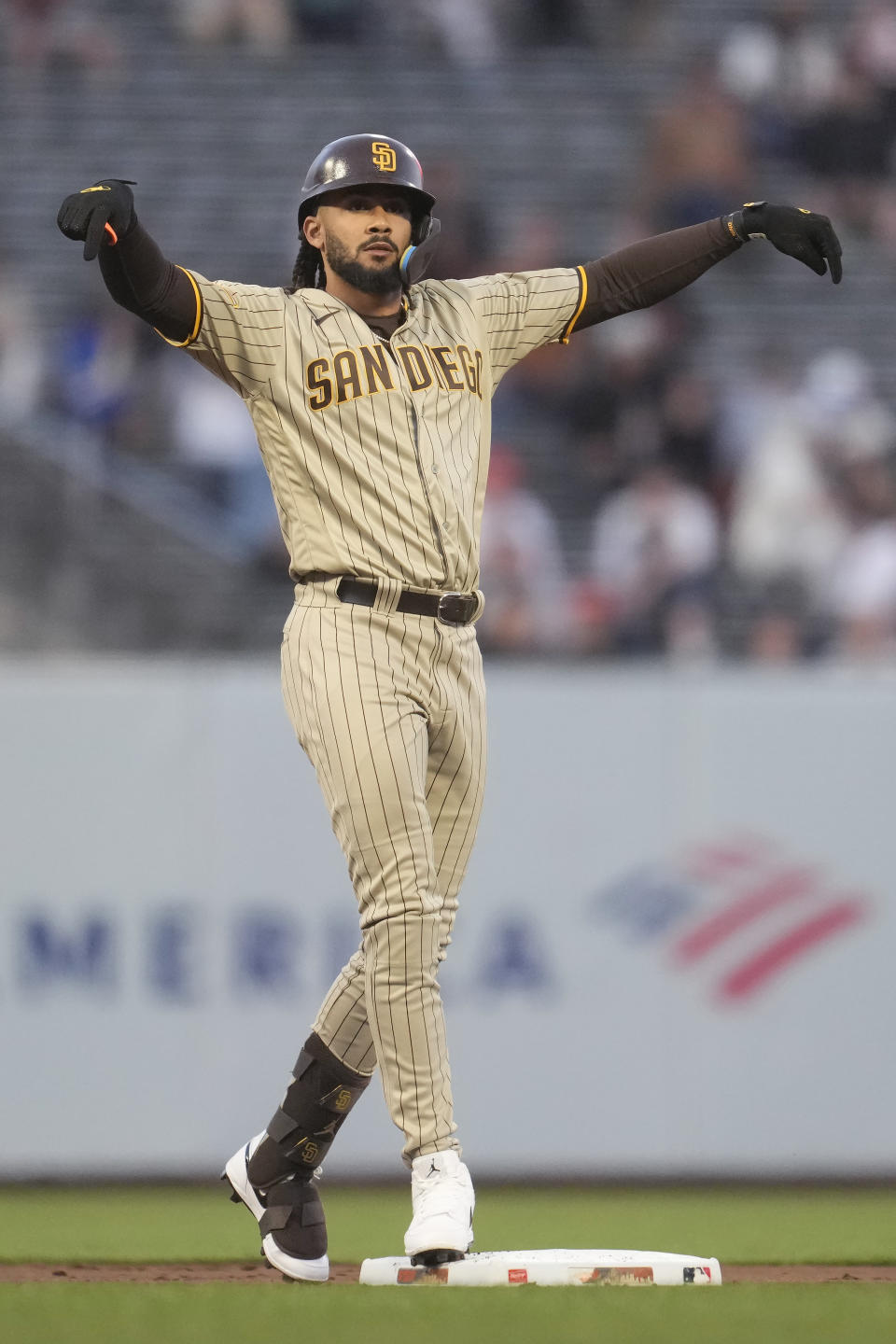 San Diego Padres' Fernando Tatis Jr. gestures toward teammates after hitting a double during the first inning of a baseball game against the San Francisco Giants in San Francisco, Monday, Sept. 25, 2023. (AP Photo/Jeff Chiu)