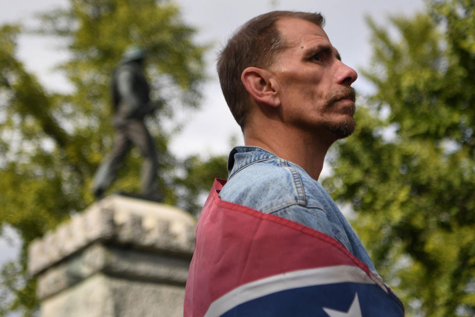 <p>“White Lives Matters” protester Keith Fuller stands below a Confederate Soldier monument while looking across at counter protesters during a rally in Murfreesboro, Tenn., Oct. 28, 2017. (Photo: Bryan Woolston/Reuters) </p>