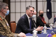 Australia's Defense Minister Richard Marles, center, watches media members leave the room during a talk with Japan's Defense Minister Yasukazu Hamada at the Iikura guesthouse in Tokyo, Friday, Dec. 9, 2022. (AP Photo/Hiro Komae)