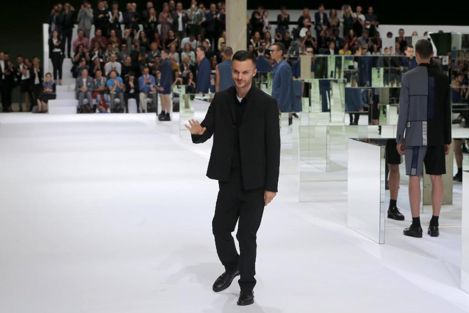Fashion designer Kris Van Assche, centre, acknowledges applause following the presentation of the men's fashion Spring-Summer 2014 collection he designed for Dior, Saturday, June 29, 2013 in Paris. (AP Photo/Jacques Brinon)