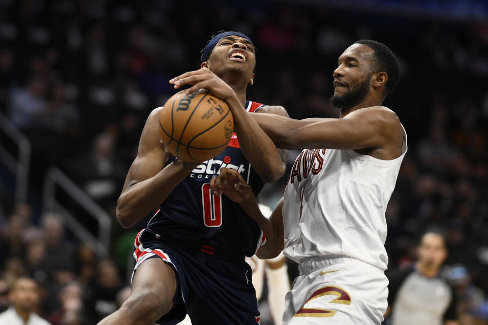 Washington Wizards guard Bilal Coulibaly (0) is defended by Cleveland Cavaliers forward Evan Mobley during the first half of an NBA basketball game Wednesday, Feb 7, 2024, in Washington. (AP Photo/Nick Wass)