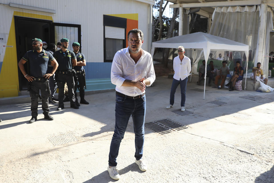 Italy's former Interior minister, Matteo Salvini and Leader of The League party, center, visits the migrant reception center in the Sicilian Island of Lampedusa, Italy, Thursday, Aug. 4, 2022. Salvini is making a stop Thursday on Italy's southernmost island of Lampedusa, the gateway to tens of thousands of migrants arriving in Italy each year across the perilous central Mediterranean Sea. (AP Photo/David Lohmueller)